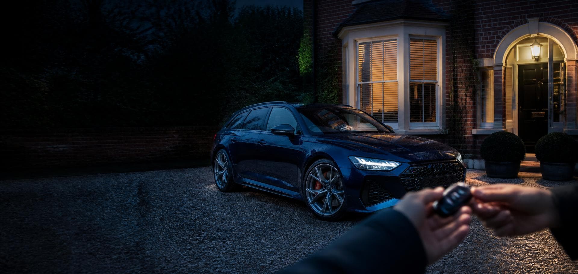 Freshly prepared car on a British driveway at dusk